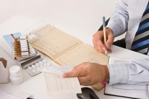 person-signing-regulatory-documents-at-desk